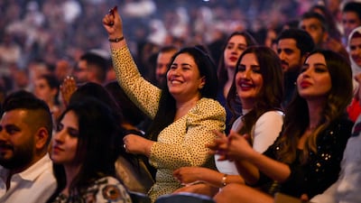 Ladies sing along to Iraqi singer, Kadim Al Sahir during the Eid concert held in Etihad Arena, Yas Island. Khushnum Bhandari / The National