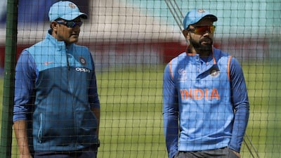 Anil Kumble, left, has left his position as India's national team cricket coach after a falling out with captain Virat Kohli, right. Matt Dunham / AP Photo