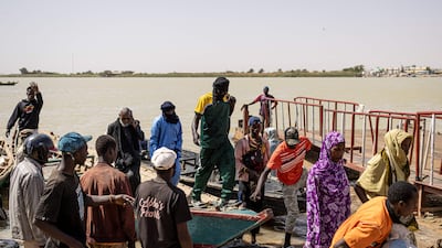 Passengers reach Senegal after crossing the Senegal River from Mauritania, which has been expelling migrants from neighbouring countries. AFP