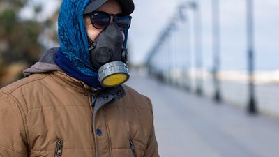A man wears a tear gas mask to help protect himself from the new coronavirus as he walks at Beirut's seaside corniche, or waterfront promenade, along the Mediterranean Sea, which is almost empty of residents and tourists in Beirut, Lebanon. For most people, the new coronavirus causes only mild or moderate symptoms, such as fever and cough. For some, especially older adults and people with existing health problems, it can cause more severe illness, including pneumonia. AP Photo