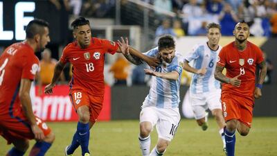 Lionel Messi is held back by Chile’s Gonzalo Jara during extra time. (EPA/Jason Szenes)