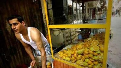 A Palestinian man sells orange juice in the Beddawi refugee camp in Tripoli. Refugees cannot own land or access national health care.