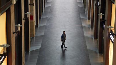 A solitary shopper passes luxury retail stores in an empty alley of Beirut Souks shopping area in Beirut, Lebanon. Bloomberg