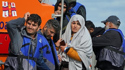 A group of people thought to be migrants are brought in to Dungeness, Kent, by lifeboat after crossing the Channel in a small vessel. PA