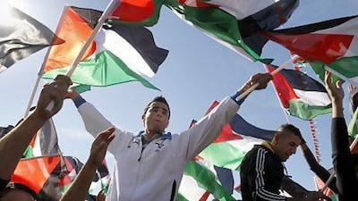 Palestinians in the West Bank city of Ramallah celebrate their successful bid to win UN statehood recognition. Israel has already announced it is to build thousands of settler homes, rejecting the borders of a future Palestinian state the UN endorsed.