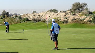 Scottish golfer Paul Lawrie puts as a C-17 Globemaster III plane takes off during the Oman Open pro-am in Muscat, on Wednesday, February 26. Getty