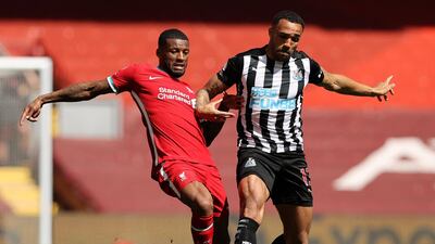 Liverpool's Georginio Wijnaldum and Newcastle substitute Callum Wilson challenge for the ball. AFP