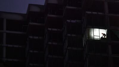 A builder works at night on a multi-storey apartment building in Kyiv, Ukraine. AFP