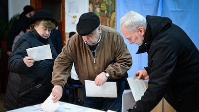 People vote in the parliamentary election at a polling station in Buzau, Romania. AFP