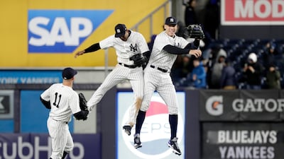 New York Yankees right fielder Aaron Judge (R) celebrates with teammates center fielder Aaron Hicks (C) and left fielder Brett Gardner (L) at the end of the game against the Toronto Blue Jays at Yankee Stadium in New York. Jason Szenes / EPA.