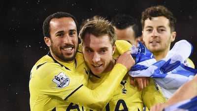 Christian Eriksen, centre, celebrates with Andros Townsend after his two goals led Tottenham to the League Cup final. Michael Regan / Getty