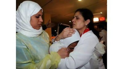 Nurses comforting a fellow nurse after she was threatened by police at Salmaniya Medical Complex in Manama, Bahrain earlier this year. MAZEN MAHDI / EPA