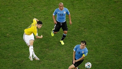 James Rodriguez of Colombia shoots and scores his team's first goal against Uruguay on Saturday at the 2014 World Cup in Rio de Janeiro, Brazil. Felipe Dana / Getty Images