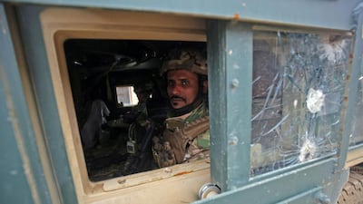 Iraqi pro-government forces patrol the eastern part of the embattled Iraqi city of Mosul, during an ongoing military operation against ISIL. Ahmad Al-Rubaye / AFP