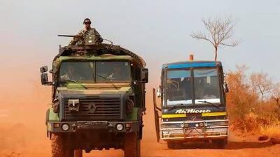 A French military convoy passes a bus in central Mali, as French and Malian forces continue their northern advance.