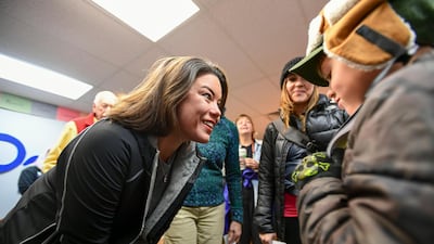 Democrat Angie Craig, who's campaigning for US House district 2, talks with a young supporter at her campaign office in Burnsville, Minnesota. EPA
