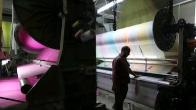 An employee monitors cotton being processed on a machine in a factory in Mahalla, Egypt. Shawn Baldwin / Bloomberg News