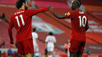 Liverpool's Sadio Mane, right, celebrates scoring his side's fourth goal with Mo Salah. AP