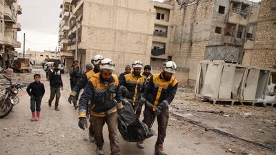 Syrian White Helmets carry a body recovered from the rubble of a building that was bombed in the town of Ariha in Idlib province. AFP