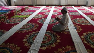 A Chinese Muslim man offers prayers on the first day of Ramadan at a mosque in Beijing on June 18, 2015. Greg Baker/AFP Photo