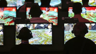 Trade visitors play computer games at Gamescom. Oliver Berg / EPA