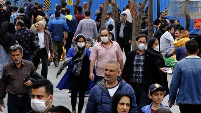 Iranians, some wearing protective masks, gather inside the capital Tehran's grand bazaar, during the Covid-19 coronavirus pandemic crises, on March 18, 2020. Iran said its novel coronavirus death toll surpassed 1,000 today as President Hassan Rouhani defended the response of his administration, which has yet to impose a lockdown. The COVID-19 outbreak in sanctions-hit Iran is one of the deadliest outside China, where the disease originated. / AFP / -