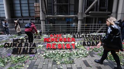 Environmental protesters leave flowers outside Lloyds of London insurance market. EPA