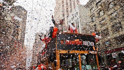 San Francisco Giants manager Bruce Bochy, top center, waves as he carries the 2014 World Series trophy during the victory parade for baseball's 2014 World Series champions on Friday in San Francisco. AP Photo/Marcio Jose Sanchez