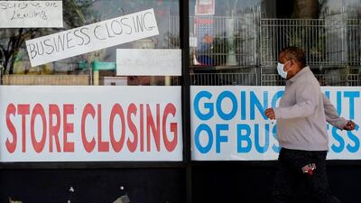 A man looks at signs of a closed store due to Covid-19 in Illinois. AP