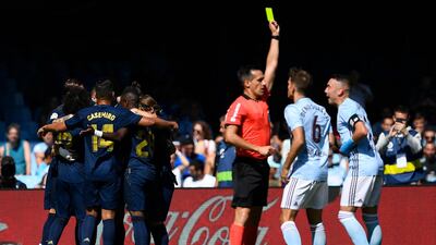 Real Madrid players celebrates after scoring the first goal as Ruben Blanco gets booked. Getty Images