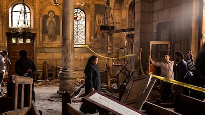 A nun walks through the site of the bombing inside the Saint Mark's Coptic Orthodox Cathedral of Abbassia in Cairo. David Degner / Getty Images