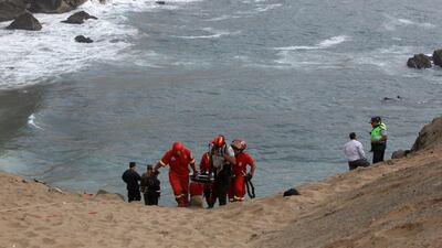 Rescue workers transport victims after a bus crashed with a truck and careened off a cliff along a sharply curved highway north of Lima, Peru, January 2, 2018. Guadalupe Pardo / Reuters