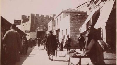 A street scene beside Jaffa Gate including a photography studio and barbers in Jerusalem, Palestine, 1898