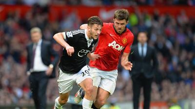 Michael Carrick shown defending Adam Lallana, then with Southampton, during a Premier League match in the 2013/14 season. Shaun Botterill / Getty Images / October 19, 2013