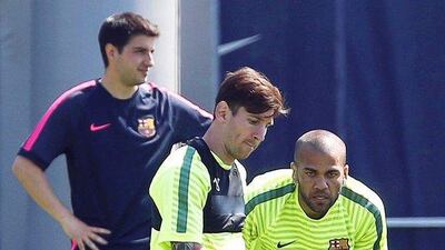 Barcelona's Lionel Messi goes through a drill on Tuesday as Dani Alves looks on during Barca's training session ahead of the Champions League final. Andreu Dalmau / EPA