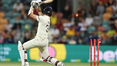 England's Mark Wood is bowled by Pat Cummins. Getty