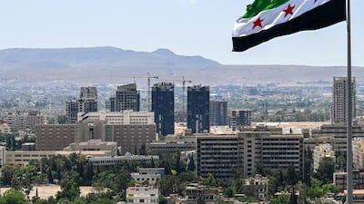A Syrian flag in Damascus. Syria has been attracting investments from its Middle East neighbours after economic sanctions were removed this year. AFP