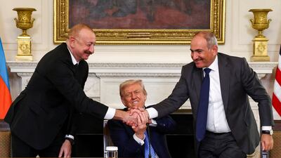 US President Donald Trump holds the hands of Azerbaijan's President Ilham Aliyev, left, and Armenia's Prime Minister Nikol Pashinyan during a trilateral signing event at the White House in Washington. Reuters