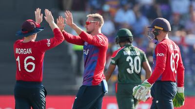 England's captain Eoin Morgan, left, congratulates teammate Liam Livingstone after taking the wicket of Bangladesh's captain Mahmudullah. AP
