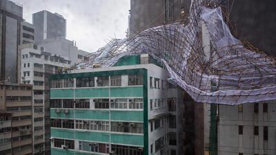 Rescue workers attempt to secure bamboo scaffolding that was damaged overnight at the top of a building in Hong Kong, during a “T8” storm signal raised for Typhoon Nida. Hong Kong shut down on Tuesday as Typhoon Nida brought violent winds and torrential rain, with hundreds of flights cancelled and the stock market, schools and businesses closed, as the storm headed across southern China. Anthony Wallace / AFP