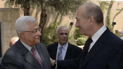 In this picture released by the Israeli government press office, the Israeli prime minister, Ehud Olmert, right, greets Palestinian president Mahmoud Abbas, as Palestinian negotiator Saeb Erekat, centre, stands nearby, during their meeting in Jerusalem on Aug 31 2008.