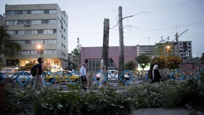 After a 15-minute period of gloom, the sandstorm began to lift and rains lashed down amid strong winds. Behrouz Mehri/AFP Photo