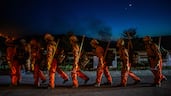 Firefighters battling the Sandy Fire in Simi Valley, California, return to their truck. The brush fire broke out in the suburbs of Los Angeles, spreading rapidly and prompting authorities to issue evacuation orders for thousands of residents. AFP