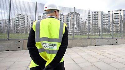 A security guard looking at the Olympic Village site, where the flats used by the athletes during the London Olympic Games are being turned into apartments for sale, rent and affordable housing at the Queen Elizabeth Olympic Park, London. Philip Toscano/ AP Photo
