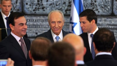 Then Israeli President Shimon Peres (C) stands alongside President of French automaker Renault-Nissan Carlos Ghosn (L) during a 2008 joint press conference at the president's residence in Jerusalem. AFP