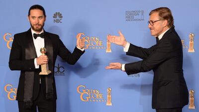 Jared Leto celebrates winning Best Supporting Actor in a Motion Picture - Drama, Musical or Comedy for Dallas Buyers Club, with actor Christoph Waltz. AFP