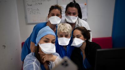 Hospital workers gather for a selfie in the Covid-19 intensive care unit of the La Timone hospital in Marseille, southern France. One of the country’s largest hospitals, La Timone has weathered wave after wave of coronavirus. AP