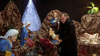 A priest sets up a cave during Christmas preparations at the Catholic church of Visitation in the West Bank village of Zababde, near Jenin. AFP