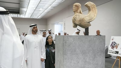 Sheikh Mohammed bin Zayed, Crown Prince of Abu Dhabi and Deputy Supreme Commander of the UAE Armed Forces, and Alia Al Mansoori, winner of the Genes in Space competition, look at the Archaic Sphinx while touring the newly constructed Louvre Abu Dhabi. Ryan Carter / Crown Prince Court - Abu Dhabi
