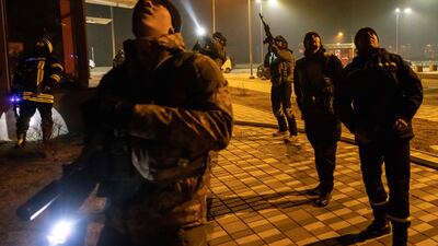 Ukrainian police officers stand near a warehouse that was hit by the debris of a downed rocket in Kyiv. AFP